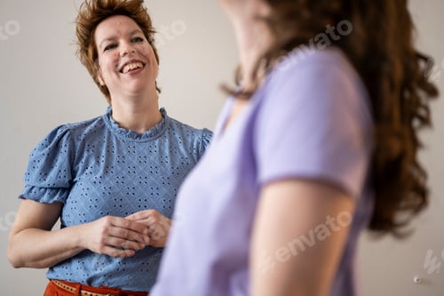 Preview: Two women sharing a joyful moment with laughter