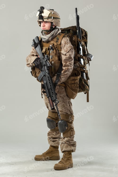 Preview: Soldier stands ready with equipment in military uniform and gear during training