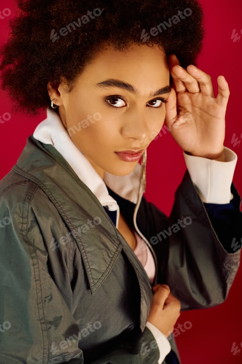 Preview: A young emotional woman expresses herself against a vibrant red backdrop in an artistic pose