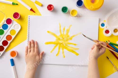 Preview: A child engages in creative painting, drawing a sun with yellow paint