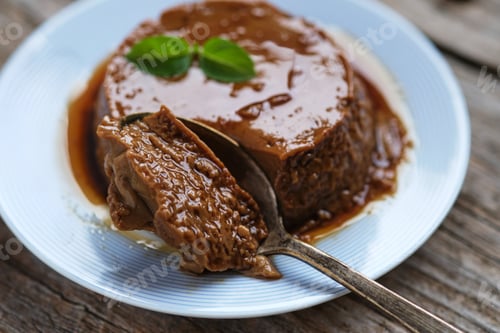 Rich and Creamy Flan Dessert on Wooden Table