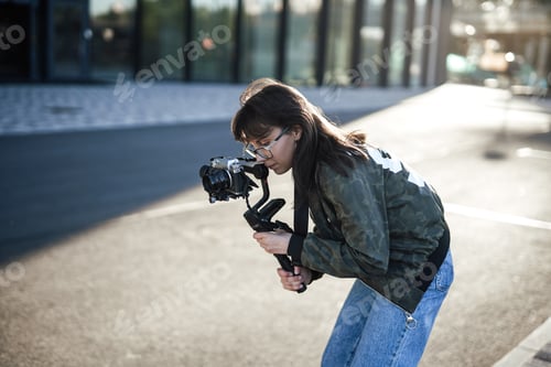 Preview: A professional female photographer is taking pictures of the city