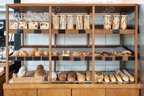Preview: Variety of fresh artisan bread and pastries display on wooden bakery shelf