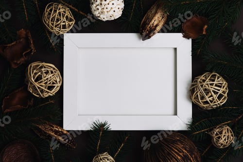 Preview: Empty picture frame with pine tree and natural christmas decoration on dark brown background Flat