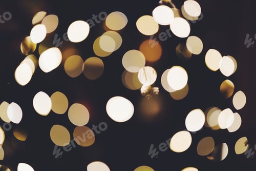 Preview: golden bokeh lights on a dark background