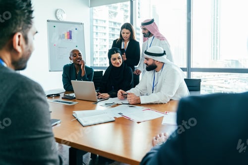 Preview: Multiethnic business team meeting in dubai office collaborating on project