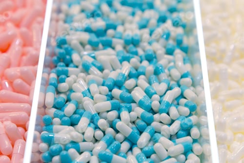 Preview: Heap of round capsule pills with medicine antibiotic, pharmacy and medical theme.