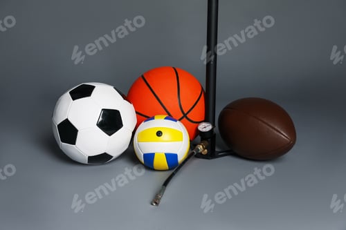 Preview: Different balls and manual air pump on grey background