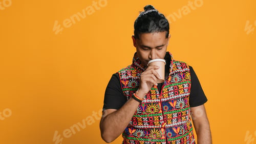 Preview: Exhausted person yawning, drinking coffee, isolated over studio background