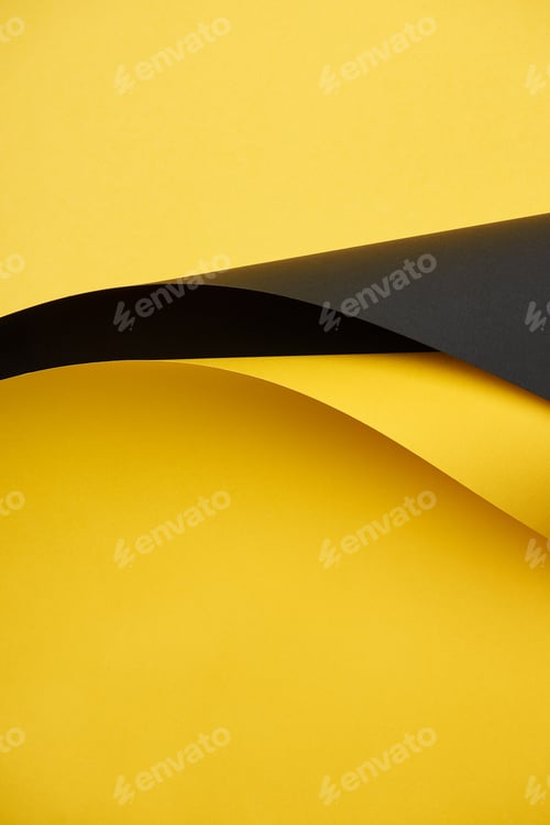 Preview: close-up view of beautiful bright yellow and black paper background
