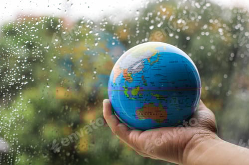 Preview: Hand holding globe with nature background