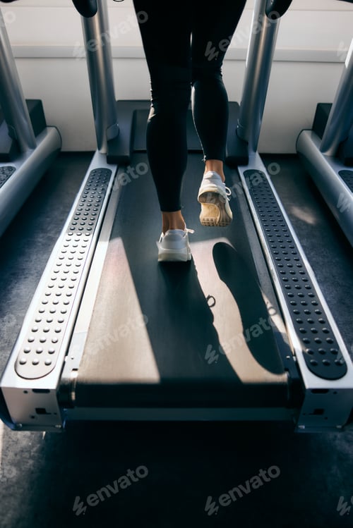 Preview: A female running on a treadmill, close-up of a shoes.