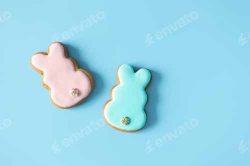 Preview: Homemade Easter cookies rabbit shape on blue background with copy space. Easter food tradition