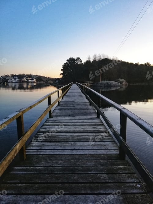Preview: Vertical shot of a boardwalk under the beautiful evening sky in Ostre Halsen, Norway