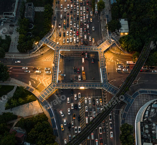 Preview: Aerial view of an intersection during the evening rush hour is filled with vehicles