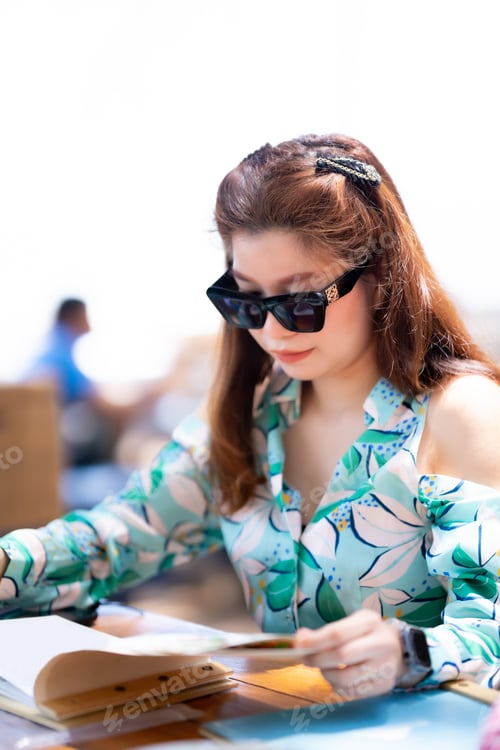 Preview: Vertical image. Portrait of Asian beautiful woman in the restaurant by the beach. Travel on vacation