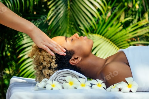 Preview: attractive african american female get treatment massage in tropics resort outdoor salon