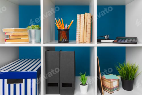 Preview: White office shelves with different stationery, close up