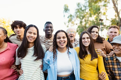Preview: Happy multigenerational people with different ethnicities having fun together in a public park