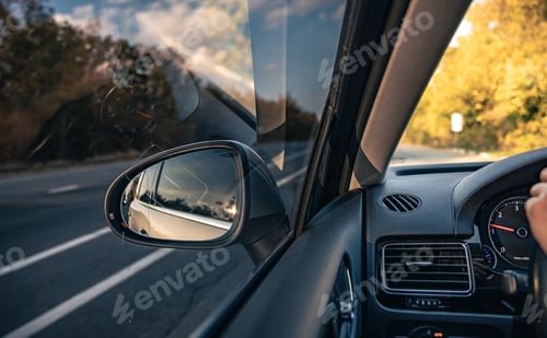 Preview: The view of the road in the car's rearview mirror.