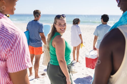 Preview: Young Caucasian woman enjoys a sunny beach day with friends