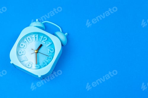 Preview: Alarm clock on color background. Pastel minimalism. Copy space