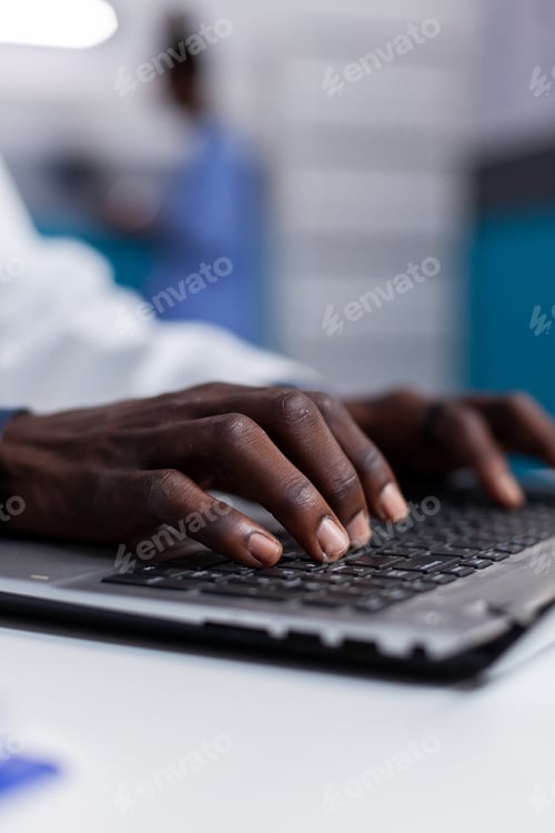 Preview: Close up of black hands typing on laptop keyboard