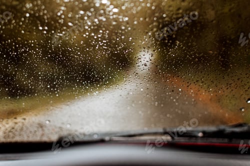 Preview: Car windshield with rain drops.