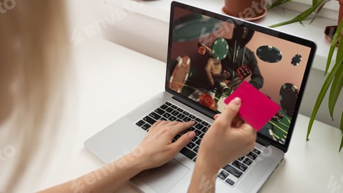 Preview: Woman with Laptop using Credit Card for Online Game