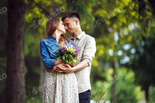 Preview: Couple in love enjoying tender moments during sunset .