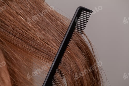 Preview: Woman on a white background with a comb for the hair, the hair problem