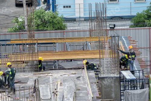 Preview: Aerial view of busy industrial construction site workers working. Development high rise building.