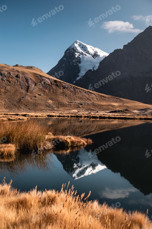 Preview: Snowy mountain reflecting in a lake in the andes mountains, peru