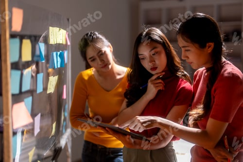 Preview: Group of young asian businesswomen brainstorming and using digital tablet during meeting
