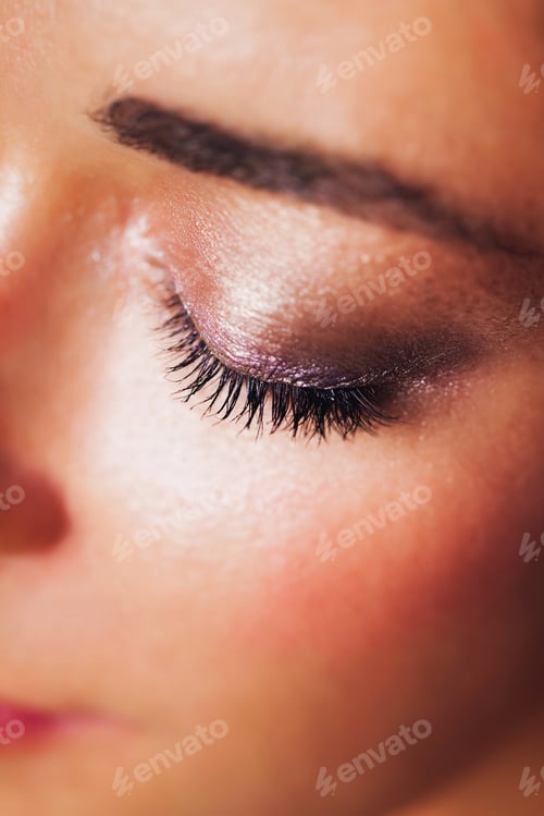 Preview: Festive glowing eyeshadow make up in brown and pink colors with shiny and glitter sparkles close up.