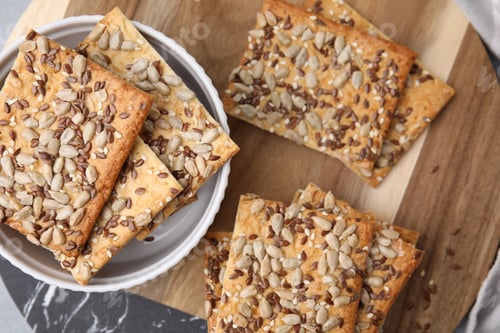 Preview: Cereal crackers with flax, sunflower and sesame seeds on table, top view