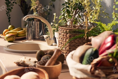 Preview: Part of sunlit kitchen with sink surrounded by fresh fruits and vegetables