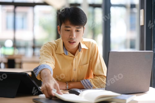 Preview: University student reading a textbook and studying for exams