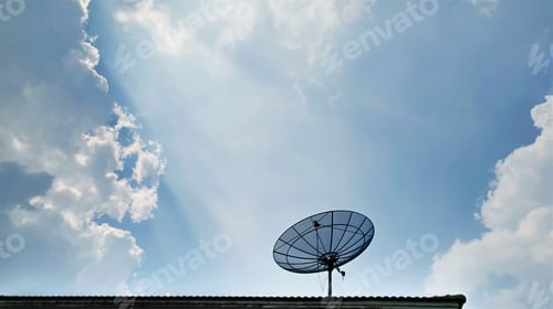 Preview: Low Angle View of Satellite Receiver Dish on the Roof Against Blue Cloudy Sky