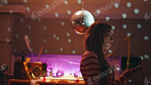 Preview: Upset woman standing night apartment with disco ball looking smartphone close up