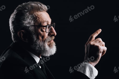 Preview: Profile headshot of grey haired scientist making report in formal black suit