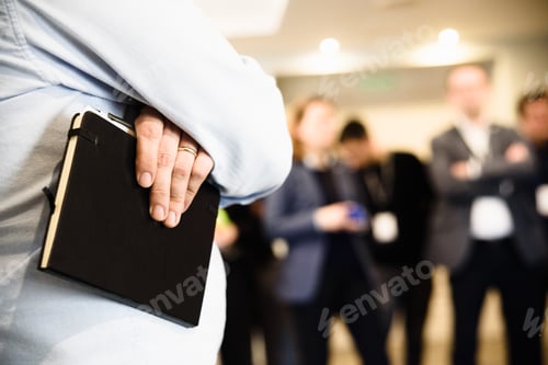 Preview: Business meeting with group of unfocused people, and in the foreground focused