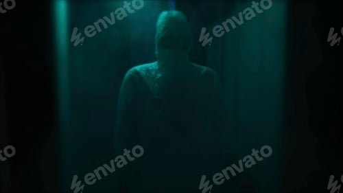 Preview: Dark blurred hospital corridor with a silhouette of a man in coverall. Stock footage. Unrecognizable