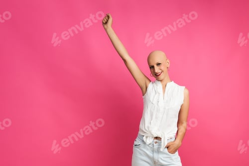 Preview: Optimistic woman after chemotherapy on pink background concept fights cancer