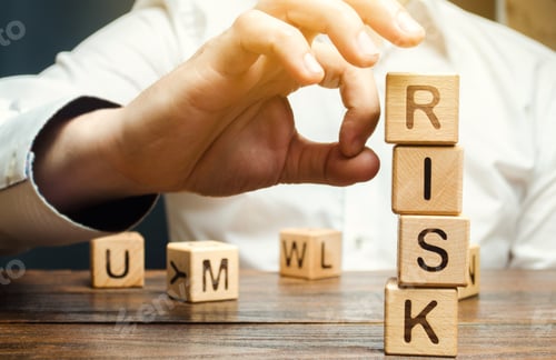 Preview: Hand removes blocks with the word Risk