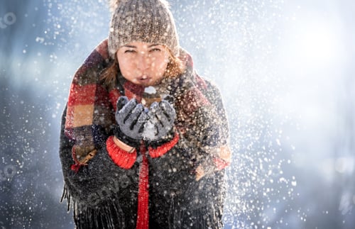 Preview: Winter magic blowing on snow by happy woman
