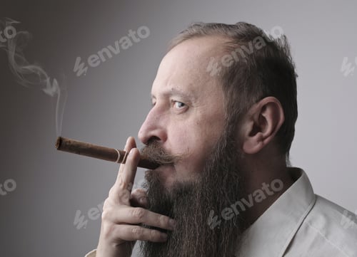 Preview: Man with a long beard and a mustache smoking a cigar with a grey wall on the background