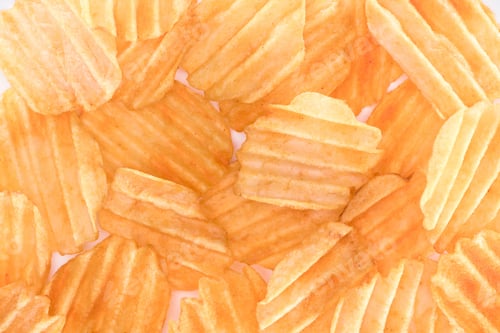 Preview: full frame view of crispy unhealthy potato chips background on white