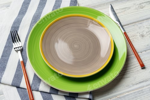 Preview: Top view of color ceramic plate on wooden background