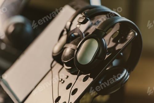 Preview: close-up shot of headphones hanging on music stand